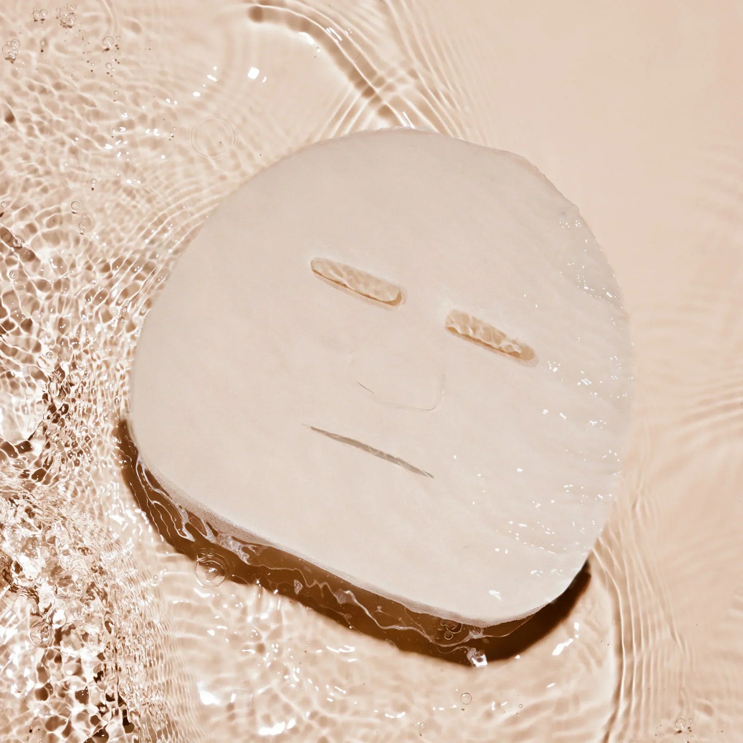 Hydrating sheet mask floating on water, minimalist skincare, clean beauty aesthetic